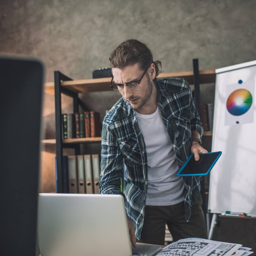 Designer Working With The Laptop And The Tablet HXDEV6Y 1024x1024
